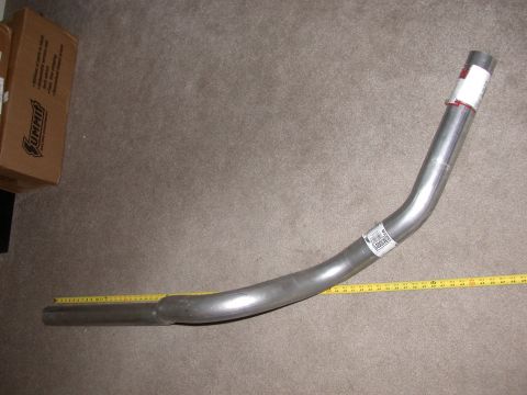 1995 Ford Bronco - A metal exhaust pipe is shown with a Summit Racing box and a measuring tape on a carpeted floor.