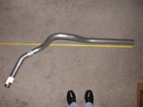 1995 Ford Bronco - A single exhaust pipe is shown with a measuring tape for scale, indicating its dimensions.