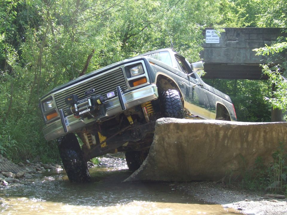 Ford truck going over an obstacle in a stream