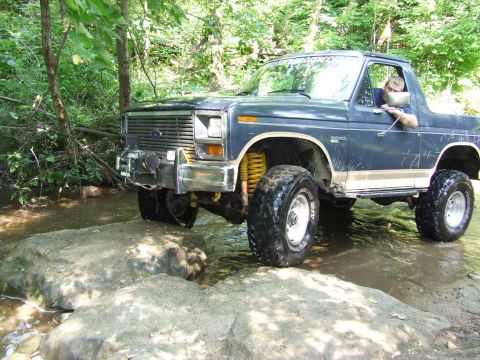 1986 Ford Bronco - This 1986 Ford Bronco navigates a challenging off-road stream crossing.
