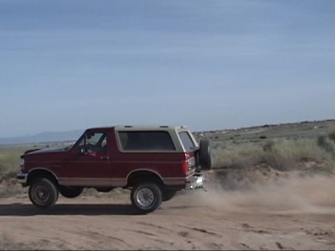 1994 Ford Bronco - This 1994 Ford Bronco is seen kicking up dust as it drives on a dirt road.