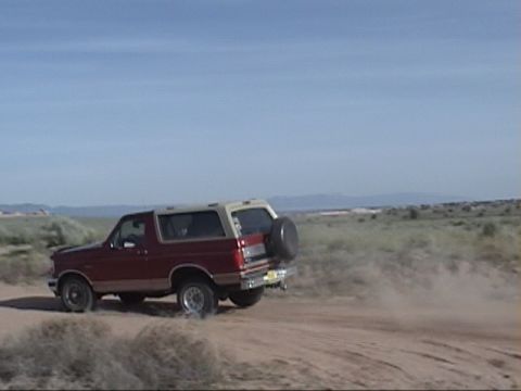 1994 Ford Bronco - This 1994 Ford Bronco kicks up dust as it drives along a desert road.