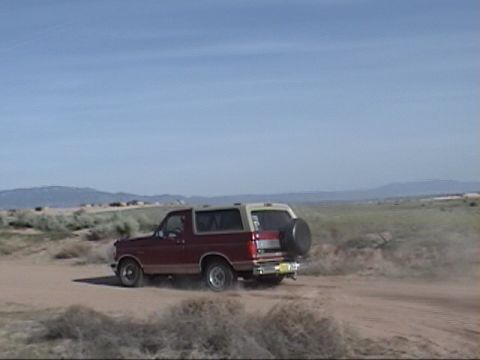 1994 Ford Bronco - This 1994 Ford Bronco kicks up dust as it drives along a desert road.