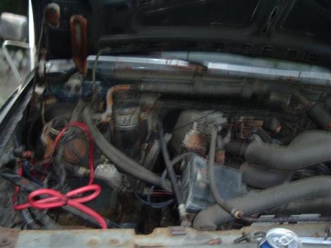 1991 Ford Bronco - The engine bay of a vehicle, showing various components and wiring.