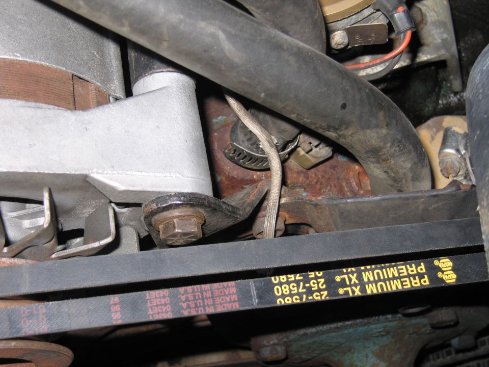 Close-up of a Premium XL 25-7580 V-belt and brackets in an engine bay