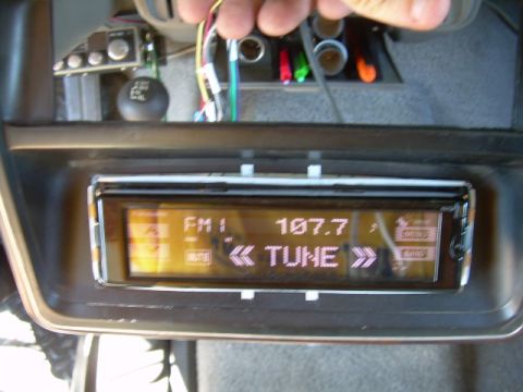 1988 Ford Bronco - Close-up of a car's dashboard showing a Panasonic head unit with its digital display active.