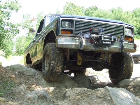 1986 Ford Bronco - This modified Ford Bronco navigates a rocky trail, its off-road capabilities.