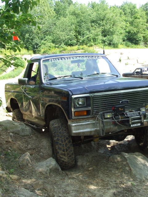 1986 Ford Bronco - This Ford Bronco navigates a rocky trail, a winch mounted on the front bumper.
