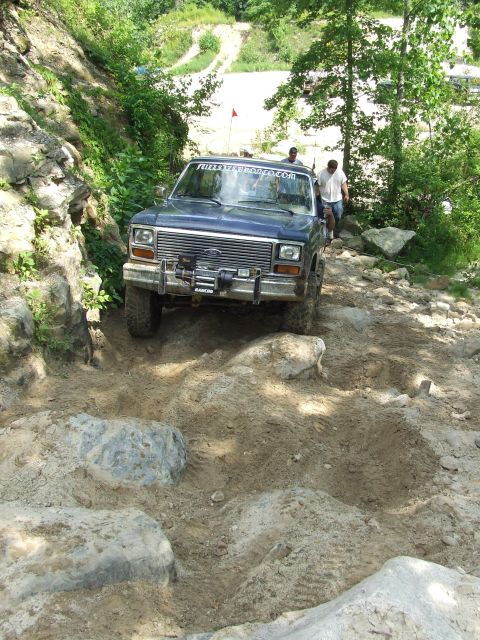 1986 Ford Bronco - Ford Bronco tackling a challenging rocky obstacle course.