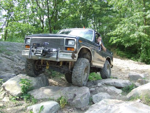 1986 Ford Bronco - This modified SUV navigates a rocky trail, its off-road capabilities.
