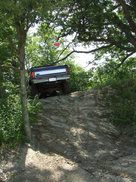 1986 Ford Bronco - A Ford F-Series pickup truck navigates a challenging off-road trail.
