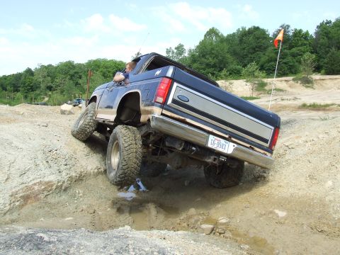 1986 Ford Bronco - This lifted Ford Bronco is navigating a challenging off-road course.