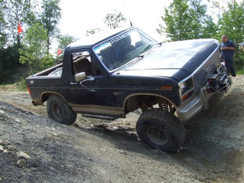 1986 Ford Bronco - This modified Ford Bronco is tackling a challenging off-road course.