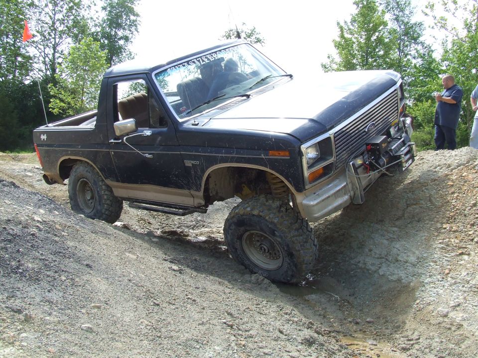 Black 1986 Ford Bronco navigating an off-road trail