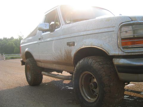 1996 Ford Bronco - Muddy 1996 Ford Bronco parked on a dirt road.