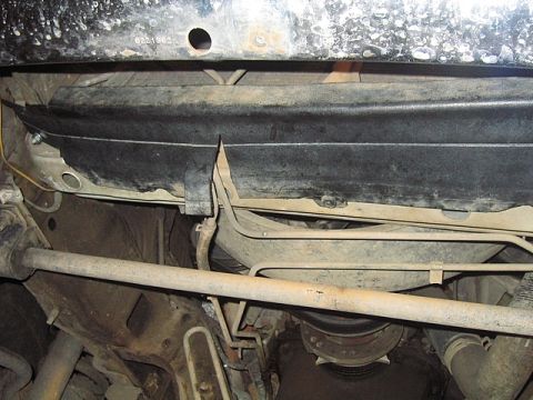 1996 Ford Bronco - Close-up view of the undercarriage, showing suspension components and fuel lines.