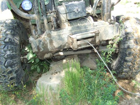 1986 Ford Bronco - Close-up of an off-road vehicle's front end, showing a winch and heavy-duty bumper.