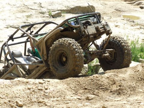 1986 Ford Bronco - This heavily modified off-road vehicle is navigating a challenging rocky terrain.