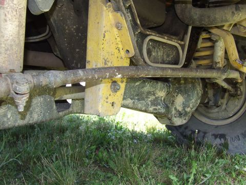 1986 Ford Bronco - Close-up view of the vehicle's undercarriage, showing suspension and steering components.