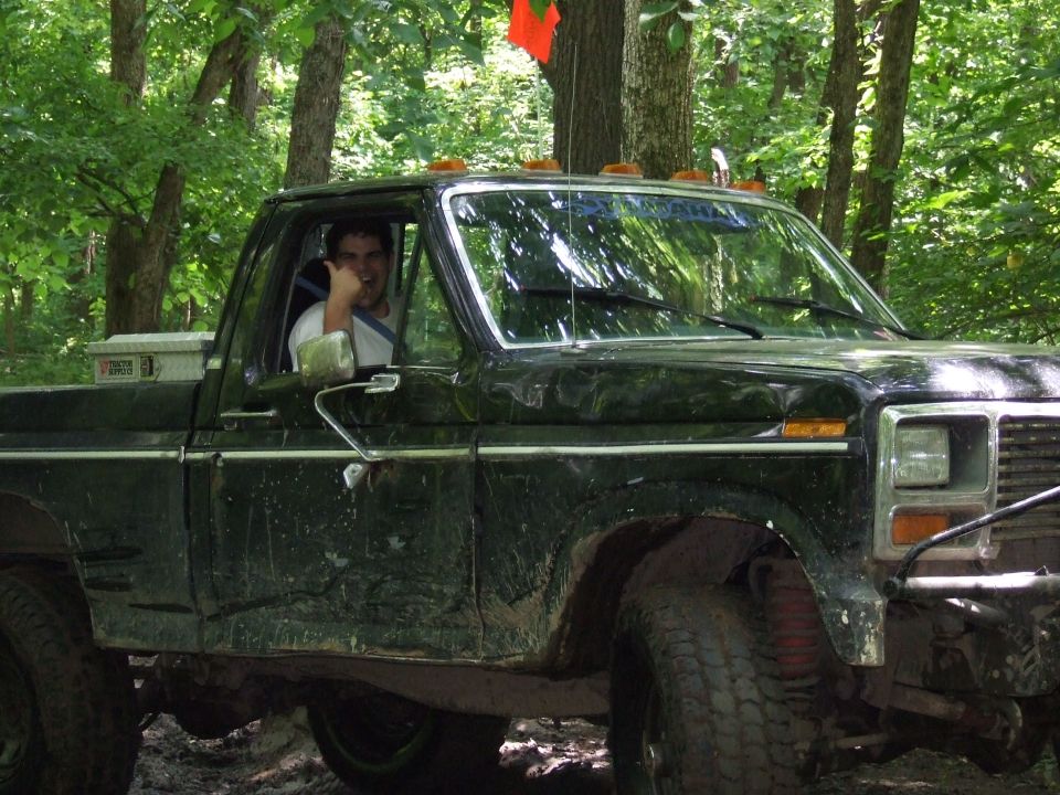 Black pickup truck, 3/4 front view, with man inside