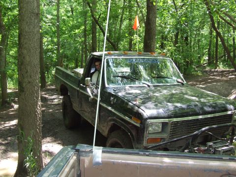 1986 Ford Bronco - Off-roading in a 1979 Ford F-150 pickup truck through a wooded area.