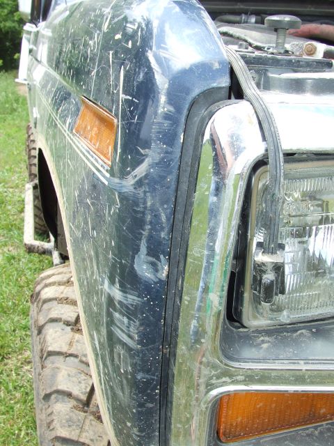 1986 Ford Bronco - Close-up of the front fender and headlight assembly on a 1986 Ford Bronco.