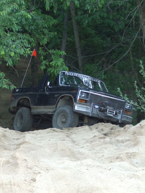 1986 Ford Bronco - This vehicle is equipped with a winch and appears to be navigating challenging off-road conditions.