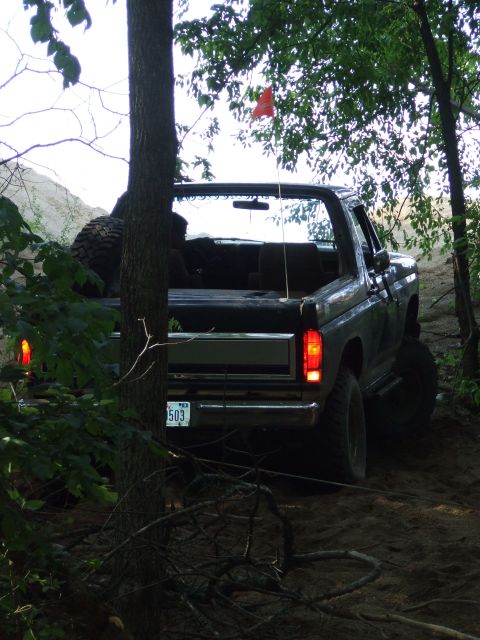 1986 Ford Bronco - This 1986 Ford Bronco is navigating a challenging off-road course, with a spare tire mounted in the rear.