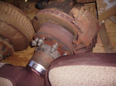 2000 Chevrolet Tahoe - Close-up of a heavily rusted brake rotor and hub assembly, likely a spare part.