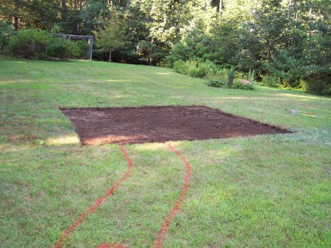 2001 Ford Crown Victoria - A patch of grass has been cleared and marked with red spray paint, indicating preparation for construction.