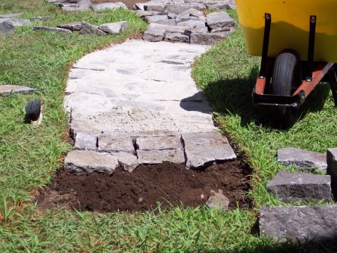 2001 Ford Crown Victoria - Construction of a stone pathway is underway, with materials and tools staged on the lawn.