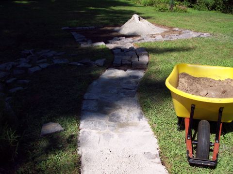 2001 Ford Crown Victoria - Construction materials are gathered for a patio build project in a backyard setting.