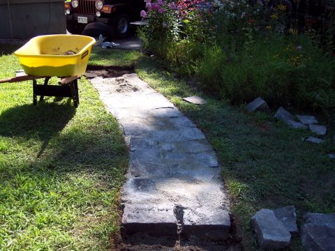 2001 Ford Crown Victoria - A brown Jeep Wrangler is visible in the background of a scene depicting a garden path being laid.