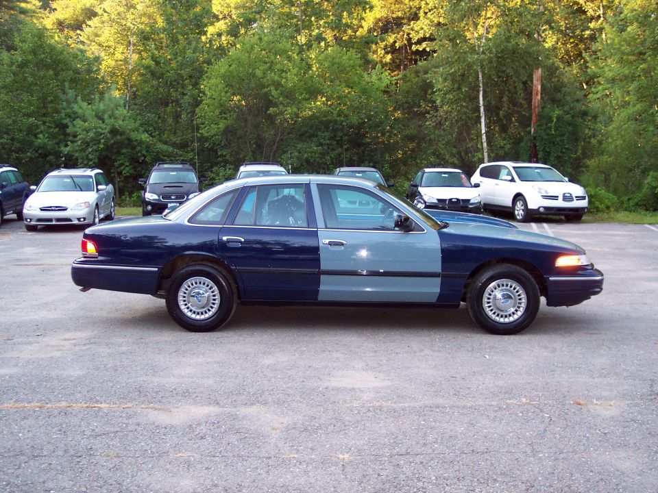 Dark blue and light blue police car parked outside