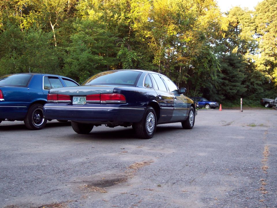 Dark blue Ford Crown Victoria, rear 3/4 view, license plate 230 4376