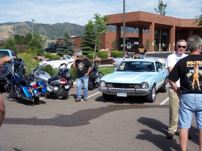 1972 Ford Ranchero - A light blue 1970 Ford Maverick is parked in a lot with several motorcycles and people.