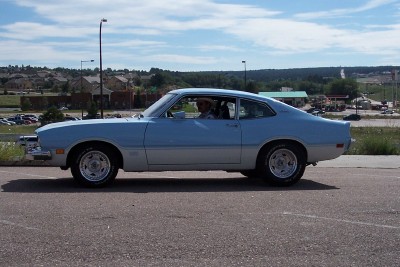 1972 Ford Ranchero - A light blue and silver two-tone 1970 Ford Maverick coupe is seen from the side on a sunny day.