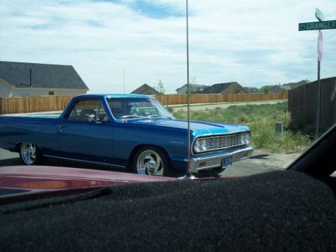 1972 Ford Ranchero - A blue 1965 Chevrolet El Camino is parked on a residential street next to a street sign.
