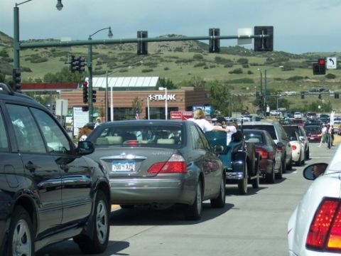 1972 Ford Ranchero - A line of vehicles are stopped in traffic on a sunny day, with a vintage car visible among them.