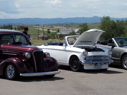 White convertible with hood open, license plate 606-RYJ