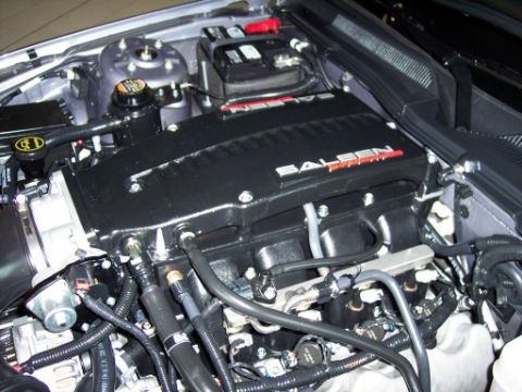 1972 Ford Ranchero - Close-up of a car's engine bay, a black intake manifold with red Saleen lettering.