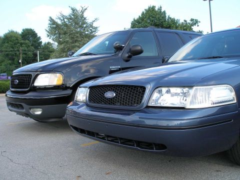 1998 Ford Crown Victoria - Two Ford vehicles, a Crown Victoria and an Expedition, are parked side-by-side.