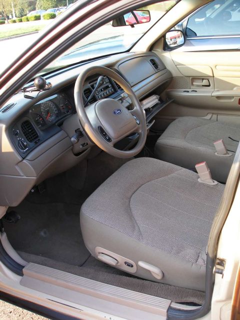 1998 Ford Crown Victoria - Interior view of a 1998 Ford Crown Victoria, highlighting the dashboard and seating.