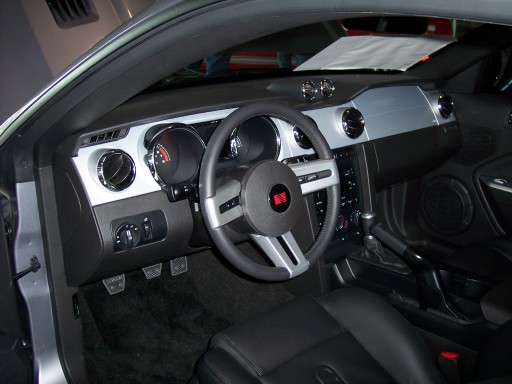 Car interior with black leather seats, dashboard, and steering wheel