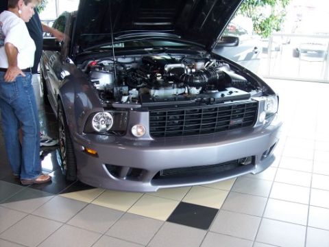 1972 Ford Ranchero - Front view of a gray Ford Mustang with its hood open, revealing the engine compartment.