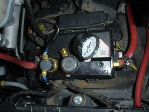 1996 Ford Bronco - Picture of the Kilby manifold mounted to the fuse box on the driver side fender well.