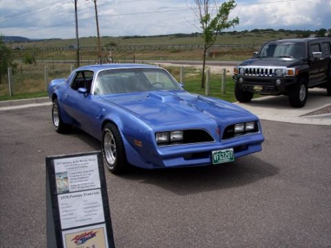 1972 Ford Ranchero - A blue 1978 Pontiac Firebird Trans Am is parked next to a black Hummer.