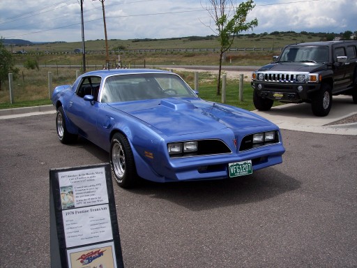 Blue 1978 Pontiac Firebird Trans Am with a hood scoop and a green license plate
