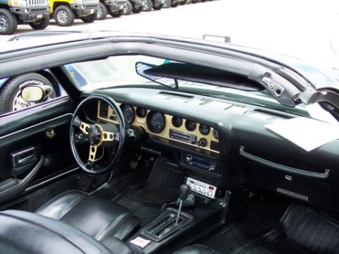 1972 Ford Ranchero - Interior view of a 1977 Pontiac Firebird Trans Am, showing the dashboard, steering wheel, and seats.