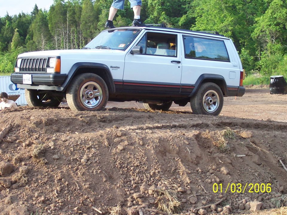 White 1995 Jeep Cherokee 3-door on dirt mound